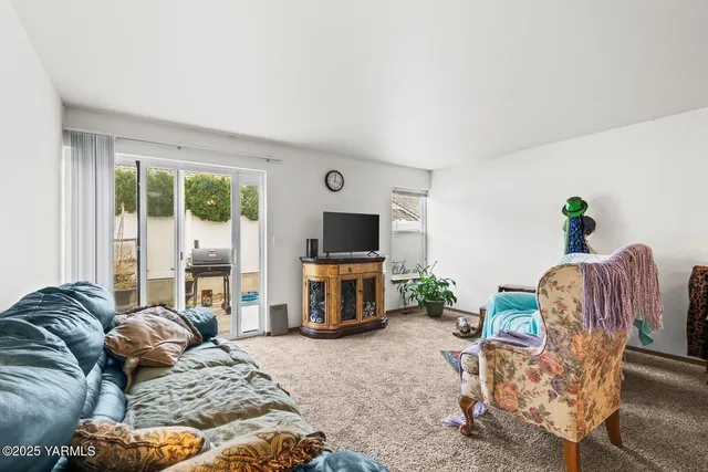 a living room with furniture flat screen tv and a fireplace