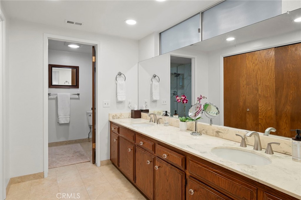 3495 Ridgecrest Drive Carlsbad, CA 92008 - Photo 29 of 42 a bathroom with a double vanity sink mirror and double