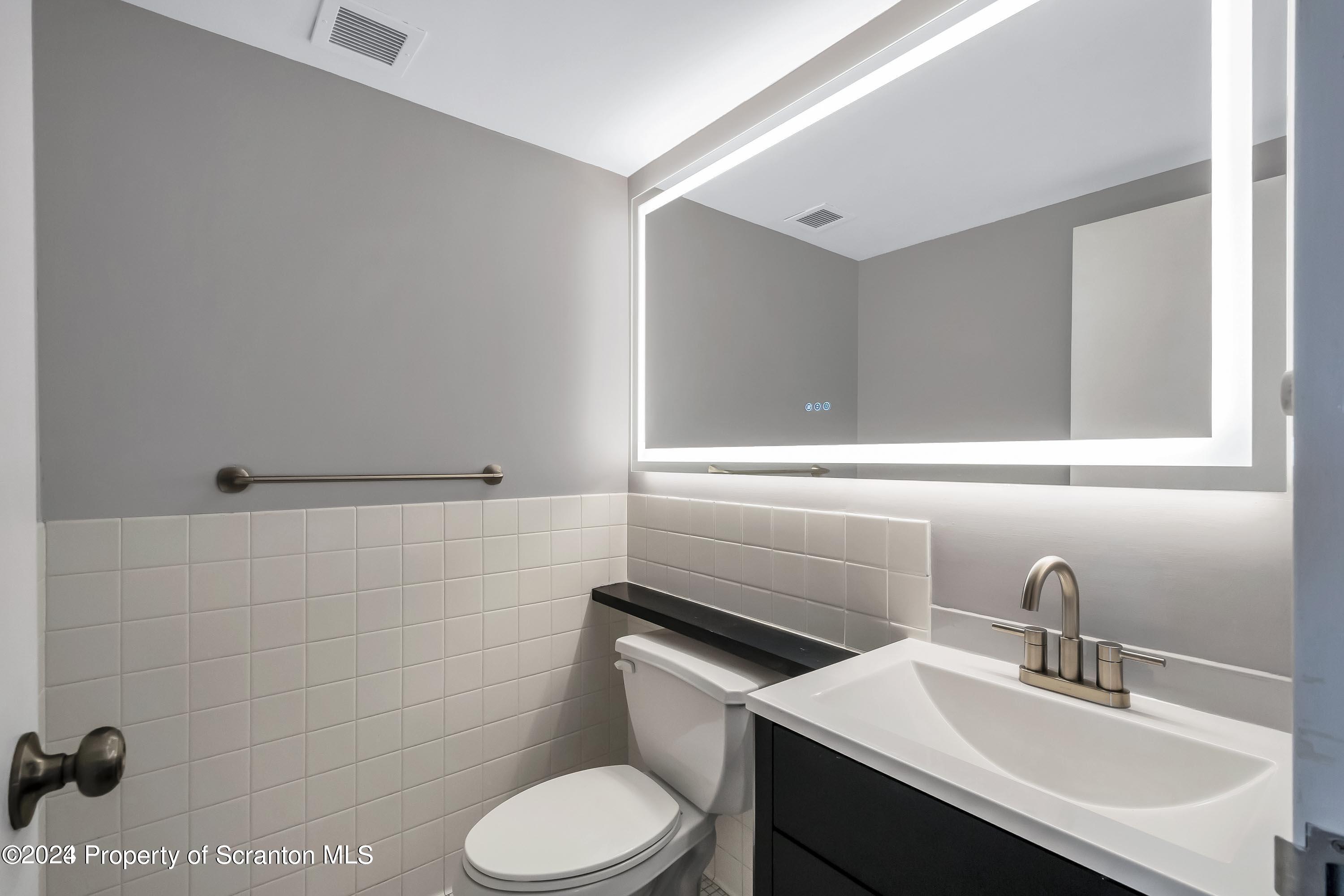 550 Clay Avenue, Unit 9B Scranton, PA 18510 - Photo 11 of 15 a bathroom with a sink toilet and vanity