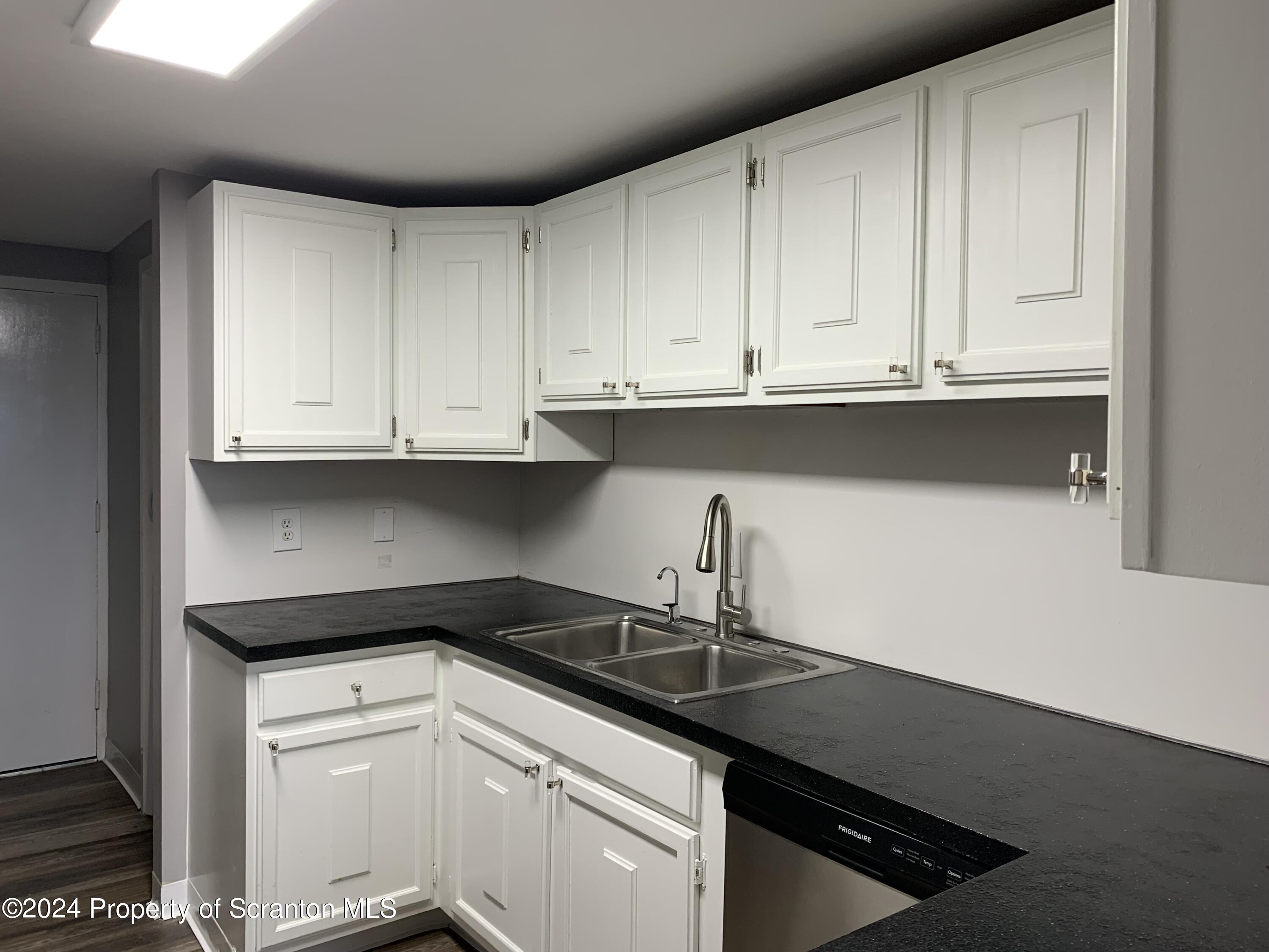 550 Clay Avenue, Unit 9B Scranton, PA 18510 - Photo 2 of 15 a kitchen with granite countertop white cabinets and a sink