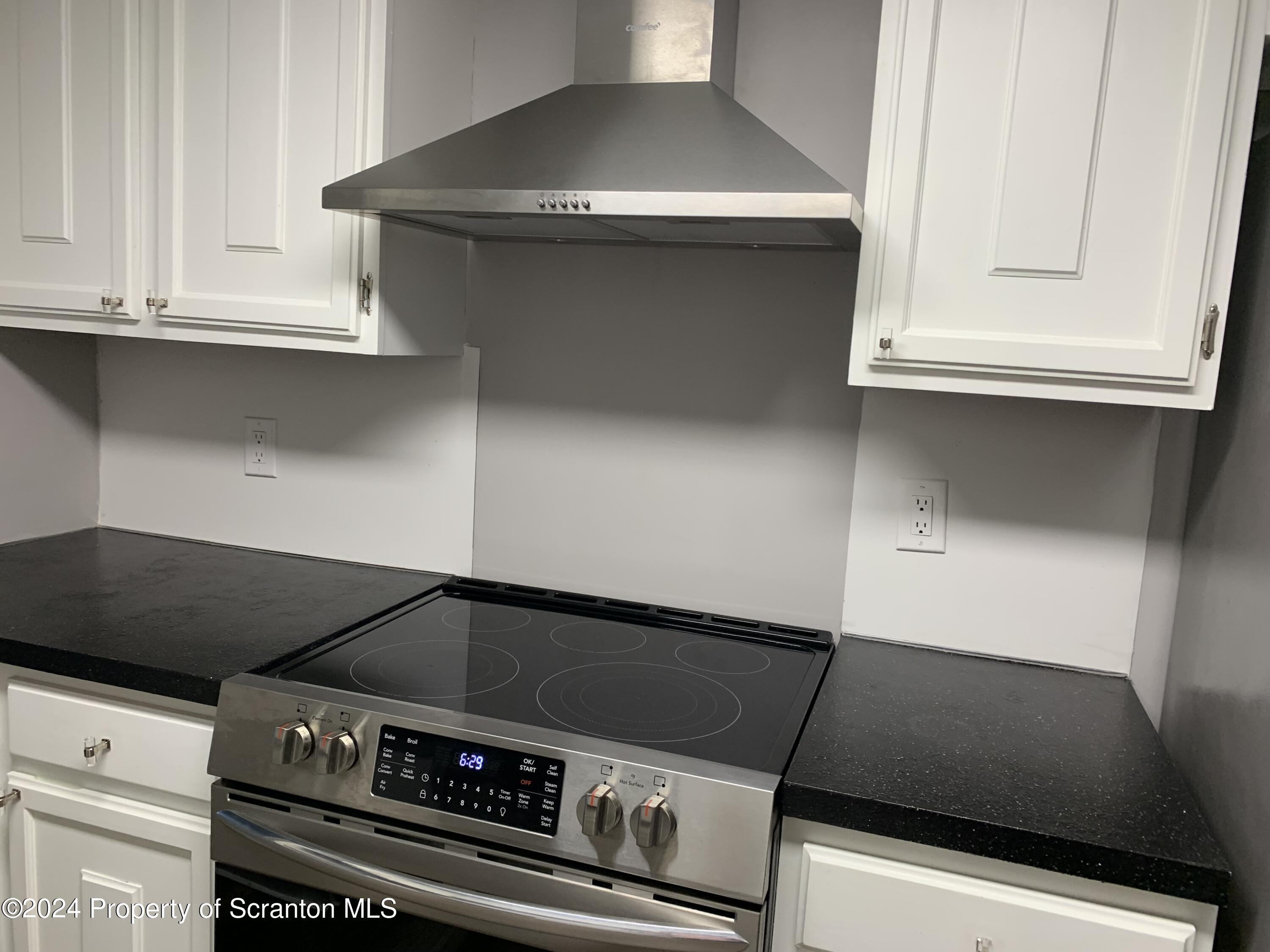 550 Clay Avenue, Unit 9B Scranton, PA 18510 - Photo 3 of 15 a stove top oven sitting inside of a kitchen