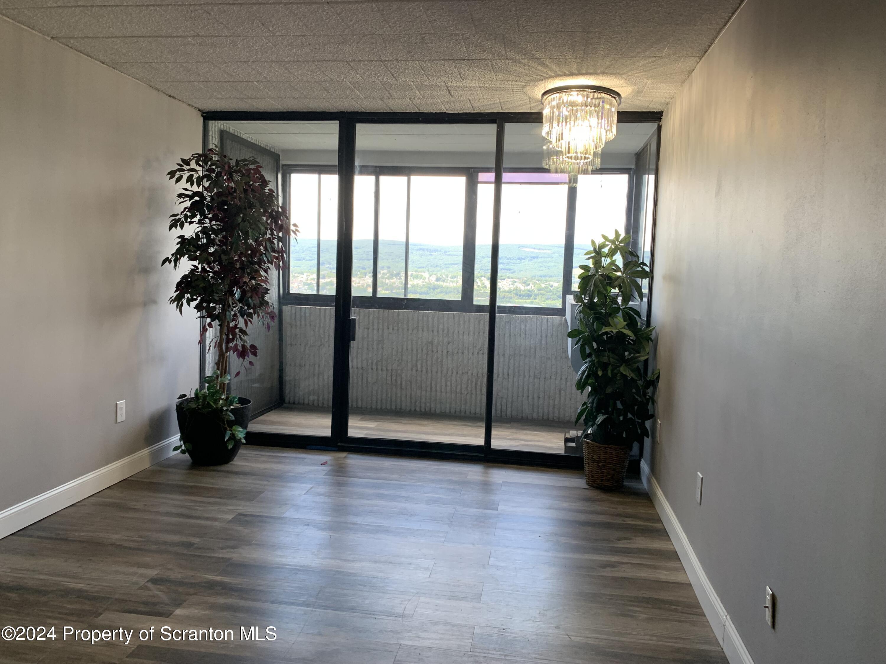 550 Clay Avenue, Unit 9B Scranton, PA 18510 - Photo 5 of 15 an empty room with wooden floor and windows