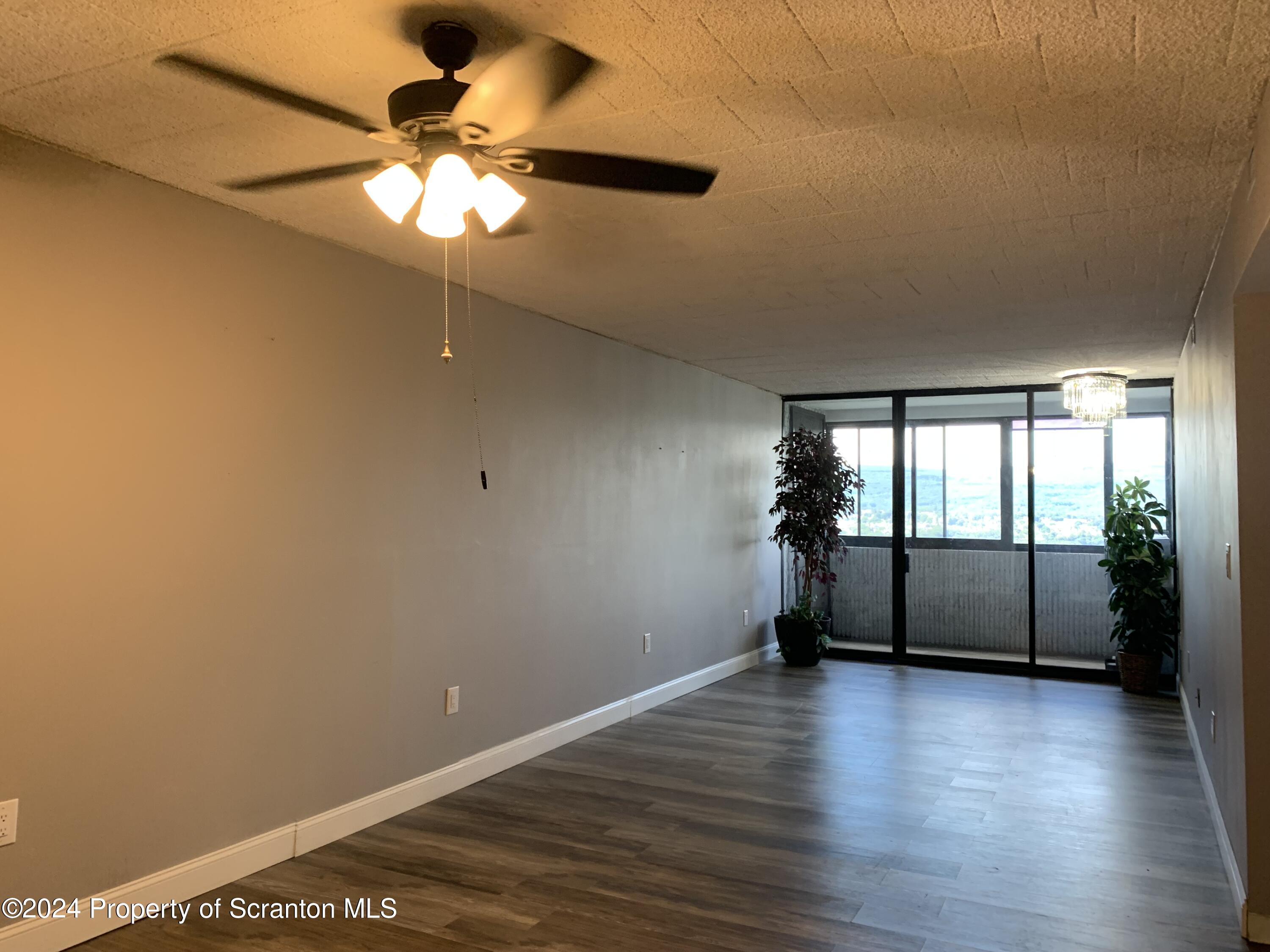 550 Clay Avenue, Unit 9B Scranton, PA 18510 - Photo 6 of 15 wooden floor in an empty room with a window