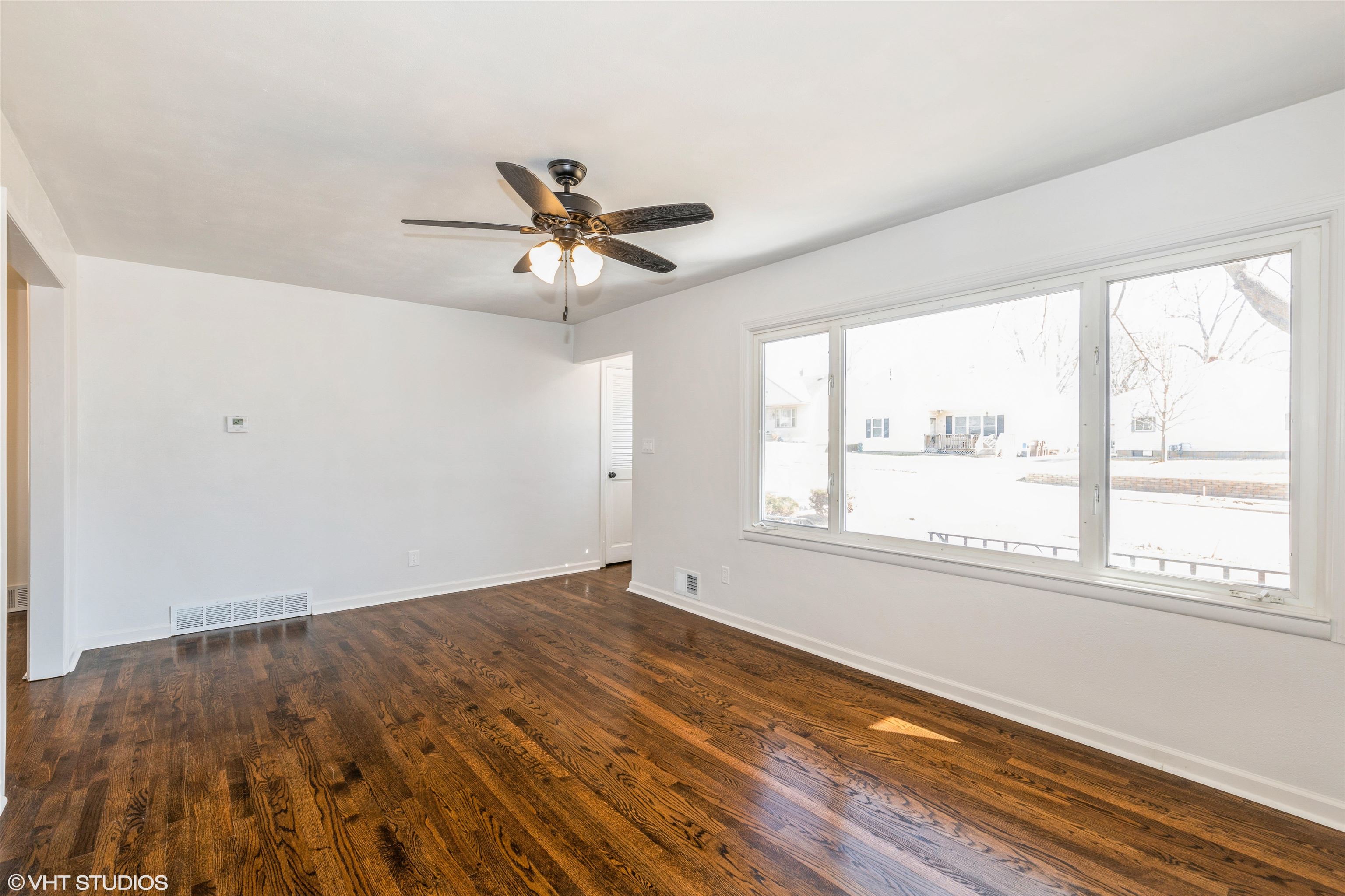 1931 Ridgeland Road Rockford, IL 61108 - Photo 7 of 26 a view of an empty room with a window and wooden floor