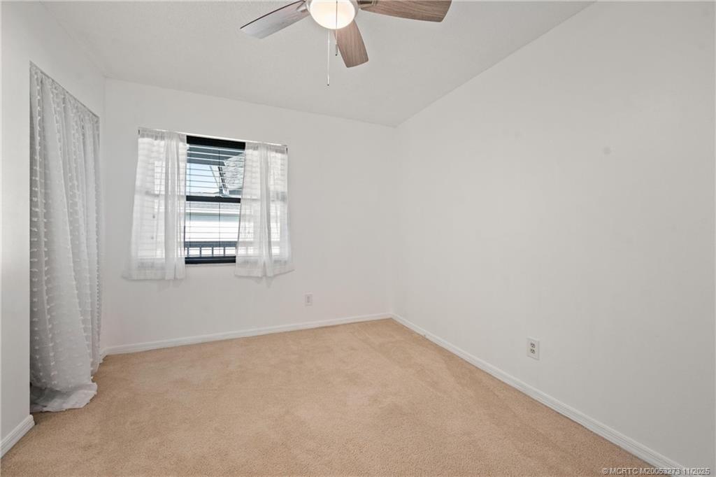 1210 Southeast Parkview Place, Unit 9 Stuart, FL 34994 - Photo 14 of 36 a view of empty room with ceiling fan