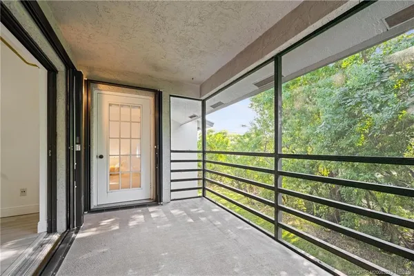 a view of a room with wooden floor and windows