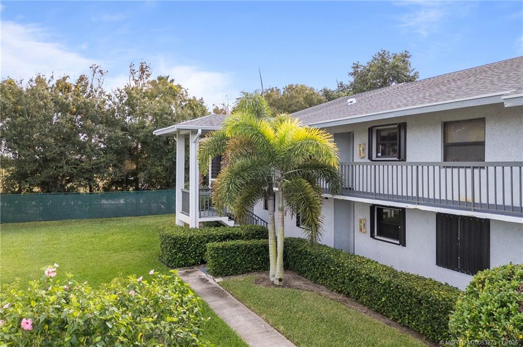 1210 Southeast Parkview Place, Unit 9 Stuart, FL 34994 - Photo 26 of 36 a front view of a house with garden