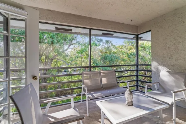 a view of a room with balcony and wooden floor