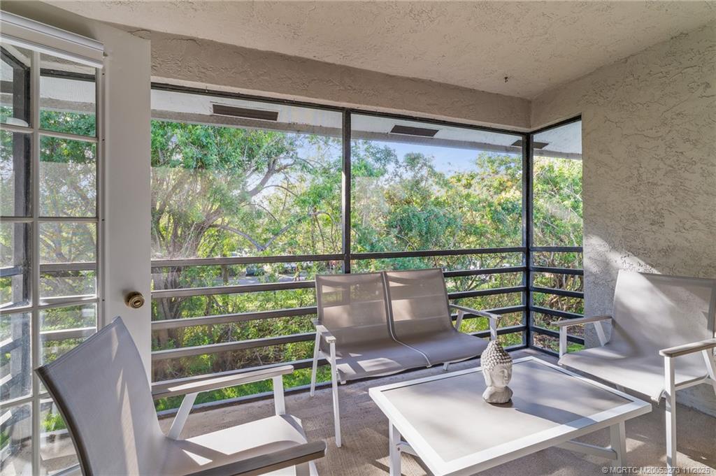 1210 Southeast Parkview Place, Unit 9 Stuart, FL 34994 - Photo 27 of 36 a view of a room with balcony and wooden floor