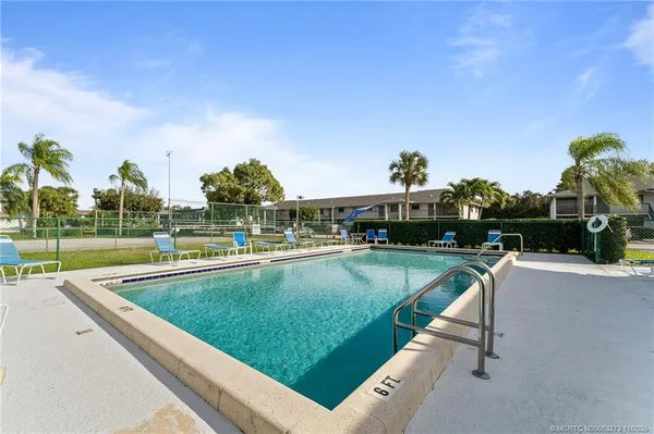 a view of swimming pool from a lounge chair