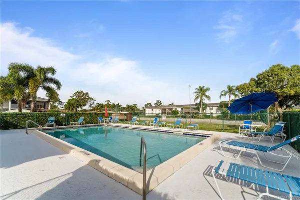 a view of a swimming pool and lounge chairs