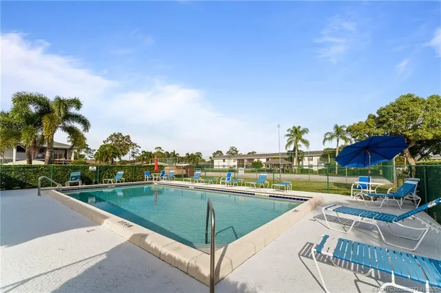 a view of a swimming pool and lounge chairs