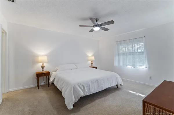 a bedroom with a bed and window