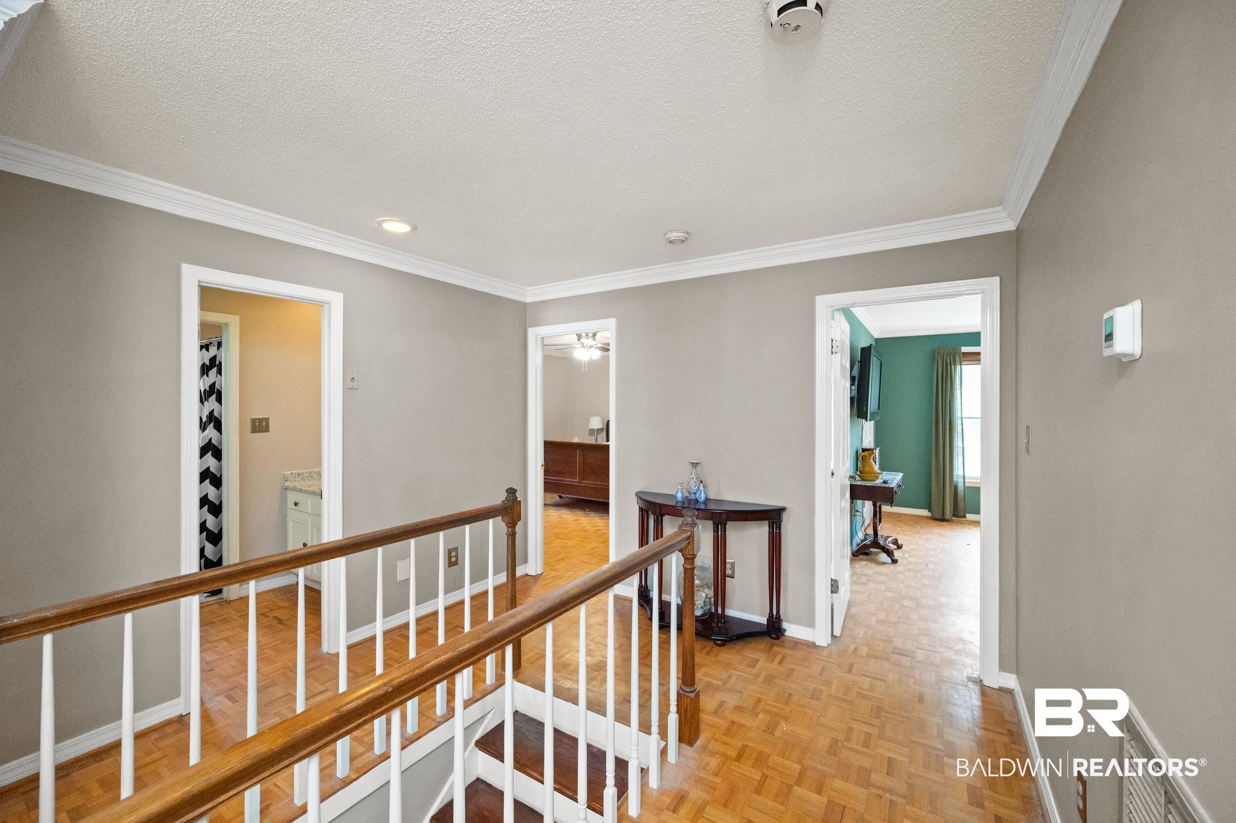 6705 Ridgeland Road South Mobile, AL 36695 - Photo 33 of 44 Hall with ornamental molding, a textured ceiling, and light parquet floors