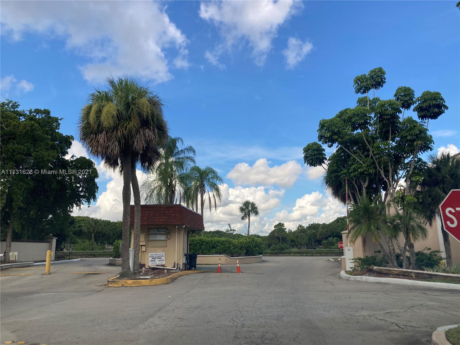 a palm tree sitting in front of a house with a yard