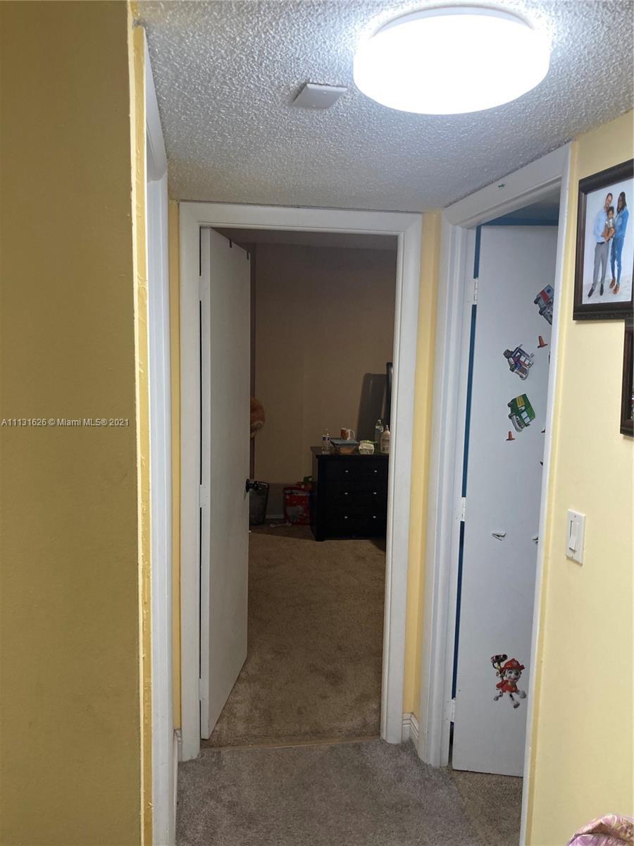 4172 Inverrary Drive, Unit 112 Lauderhill, FL 33319 - Photo 12 of 18 a view of a hallway with a livingroom and a bathroom