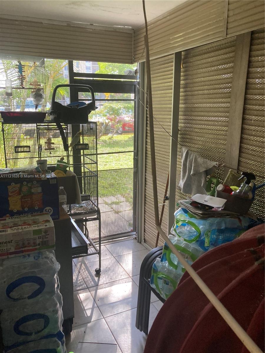 4172 Inverrary Drive, Unit 112 Lauderhill, FL 33319 - Photo 14 of 18 a view of a porch with furniture and floor to ceiling window