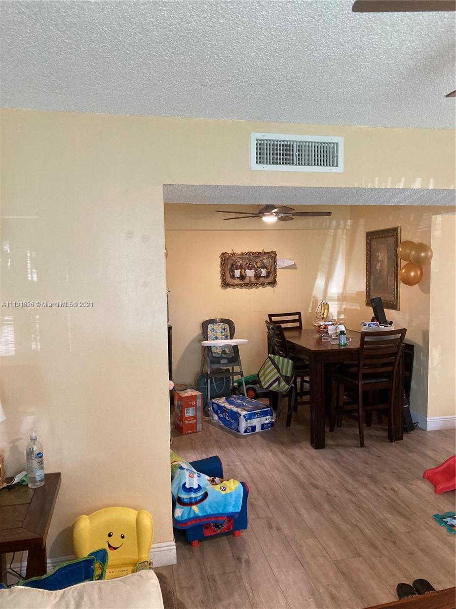 4172 Inverrary Drive, Unit 112 Lauderhill, FL 33319 - Photo 4 of 18 a living room with furniture and a dining table