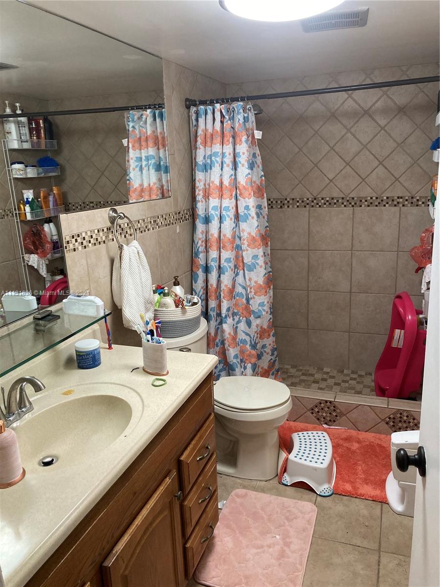 4172 Inverrary Drive, Unit 112 Lauderhill, FL 33319 - Photo 6 of 18 a bathroom with a sink and a mirror
