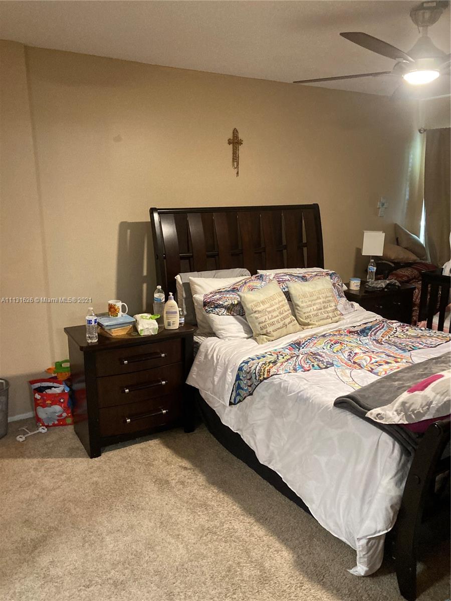 4172 Inverrary Drive, Unit 112 Lauderhill, FL 33319 - Photo 8 of 18 a bedroom with a bed and a night stand