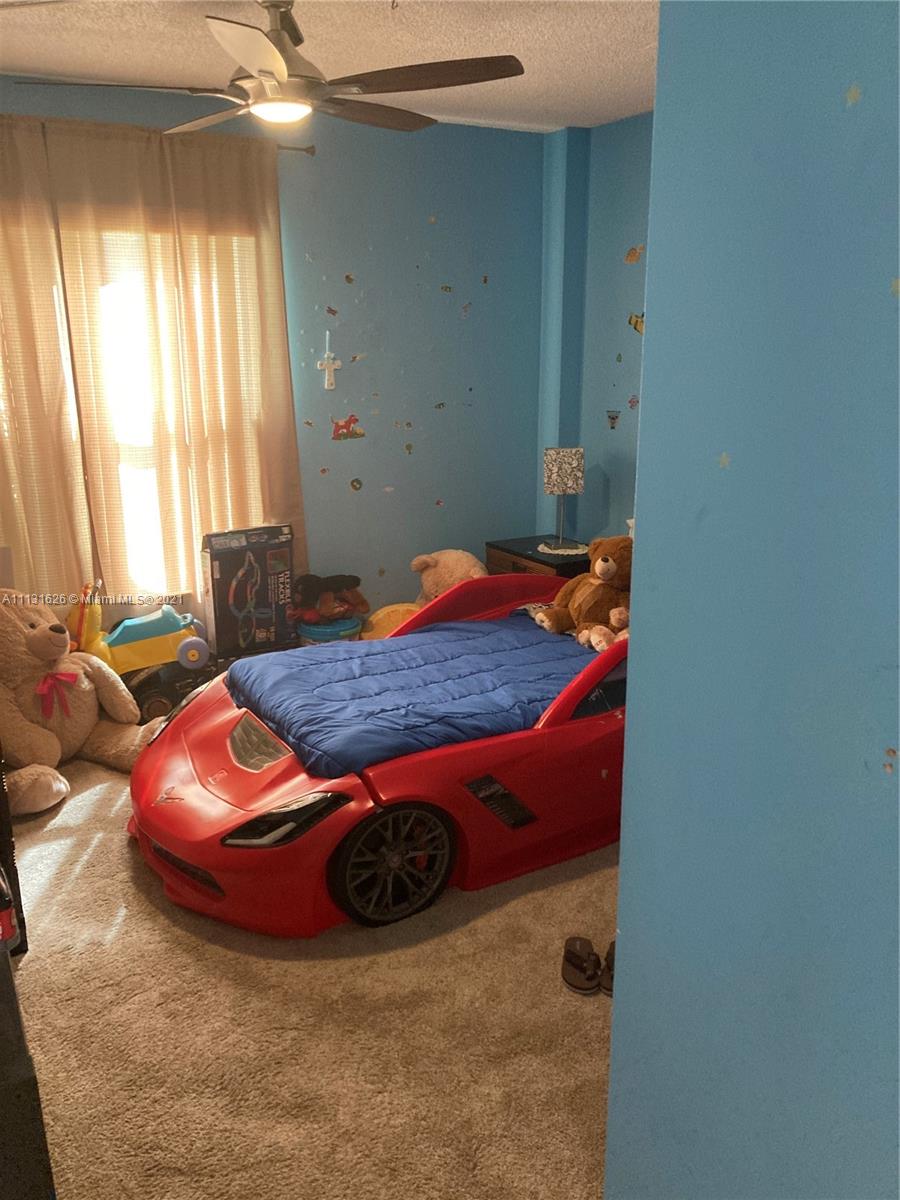 4172 Inverrary Drive, Unit 112 Lauderhill, FL 33319 - Photo 9 of 18 a bedroom with a bed and window