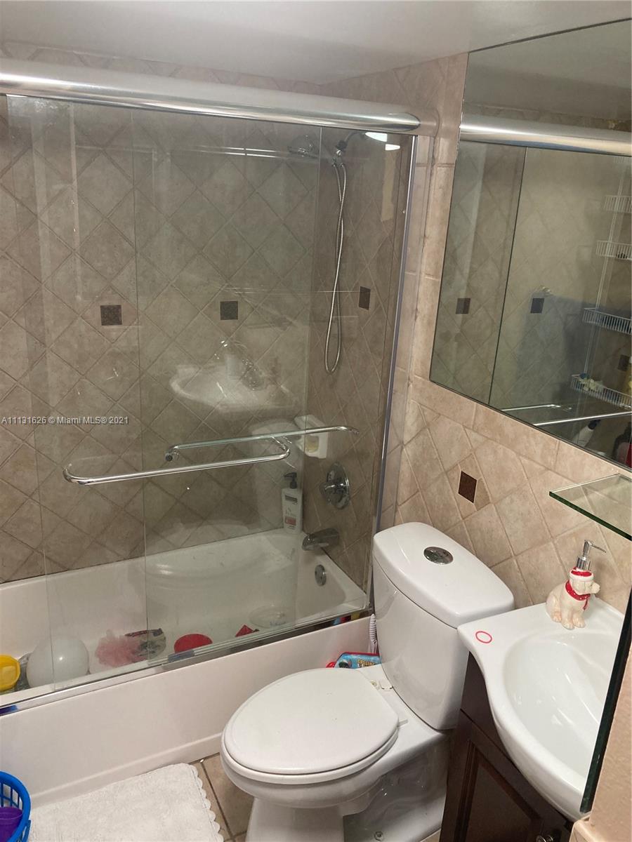 4172 Inverrary Drive, Unit 112 Lauderhill, FL 33319 - Photo 10 of 18 a white toilet and shower