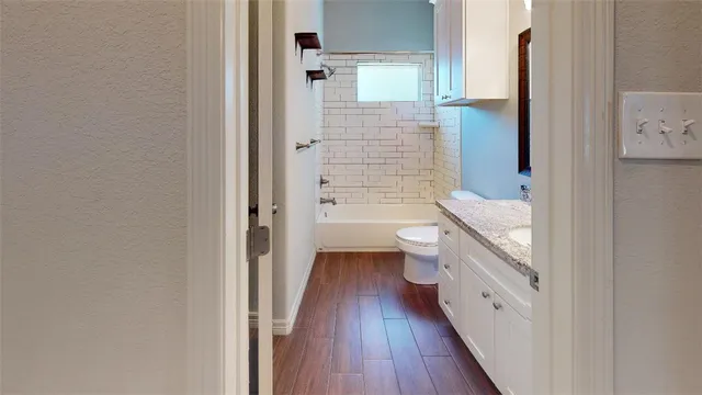 an empty room with a window and a ceiling fan