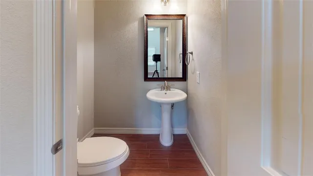 an empty room with a chandelier fan and windows