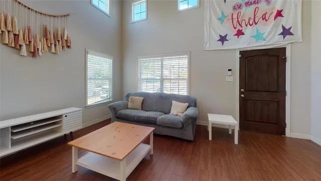 a living room with furniture a wooden floor and a window
