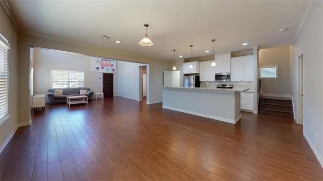 a bed sitting in a bedroom next to a lamp