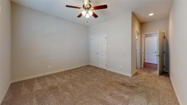 a bathroom with a granite countertop toilet sink and mirror