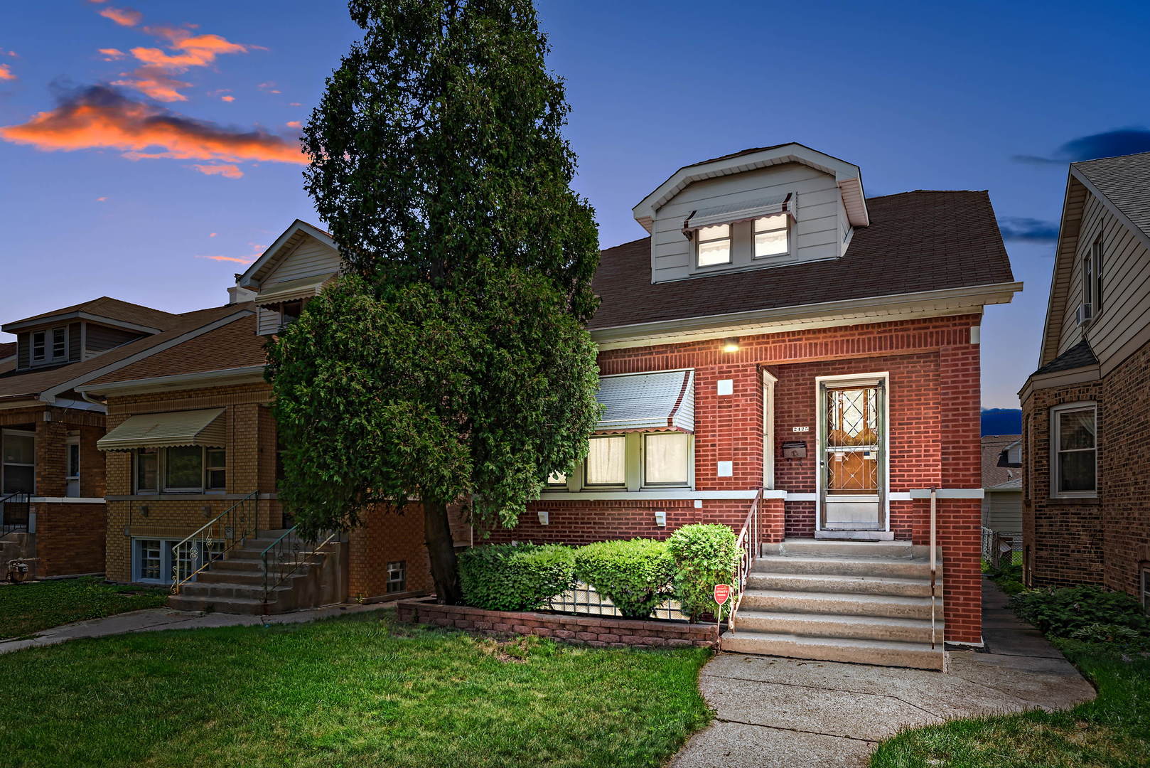 2425 North Mango Avenue Chicago, IL 60639 - Photo 1 of 17 a front view of a house with a yard