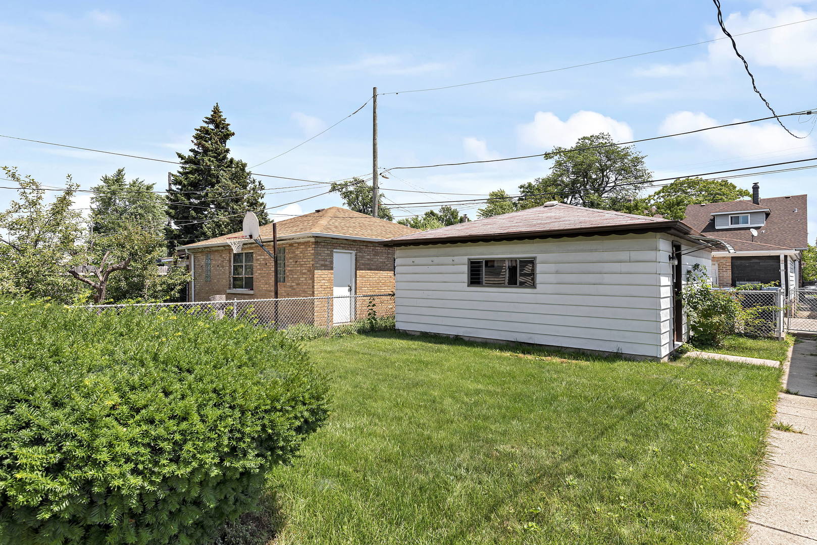 2425 North Mango Avenue Chicago, IL 60639 - Photo 17 of 17 a front view of a house with a yard