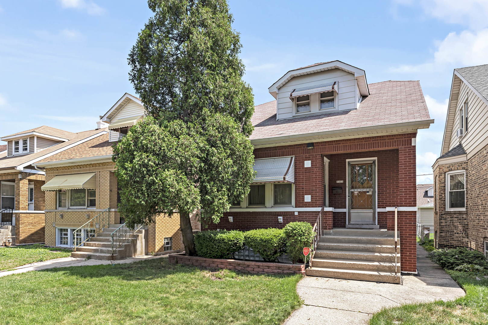 2425 North Mango Avenue Chicago, IL 60639 - Photo 2 of 17 front view of a house with a yard