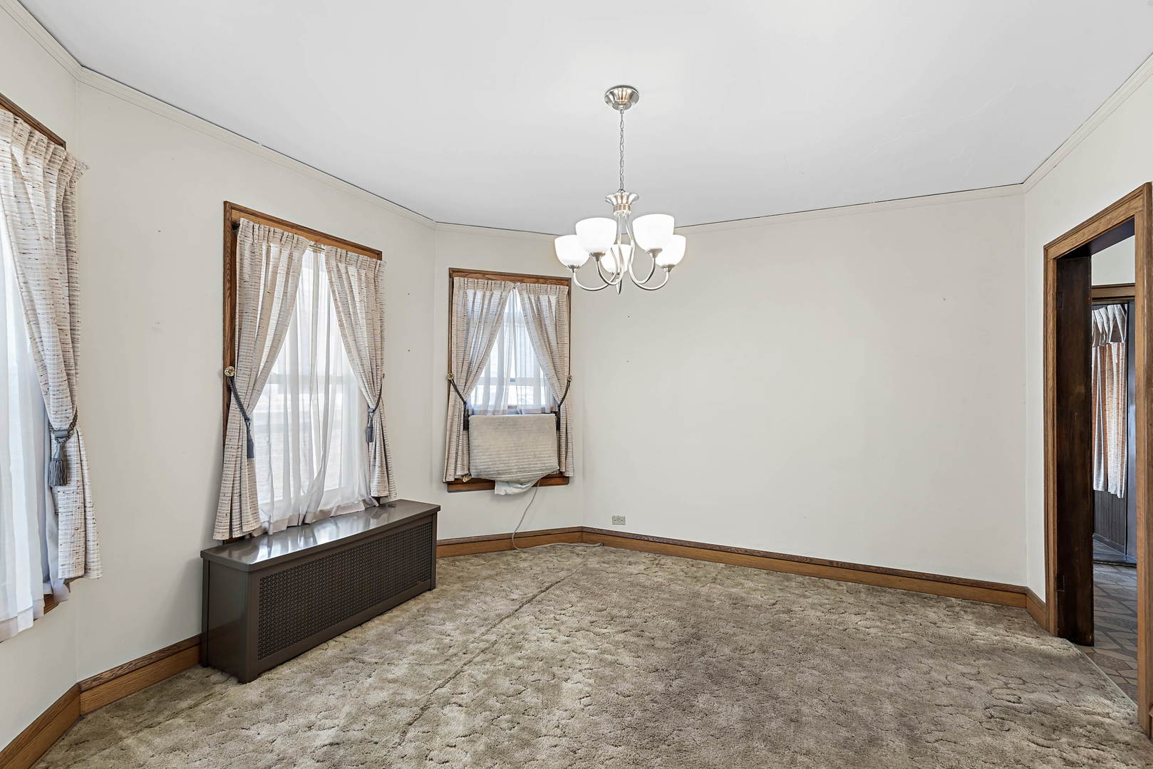 2425 North Mango Avenue Chicago, IL 60639 - Photo 5 of 17 a bed room with a bed and a chandelier