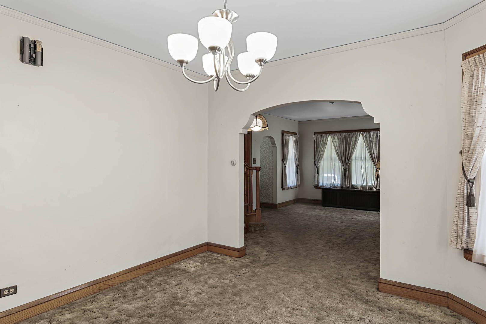 2425 North Mango Avenue Chicago, IL 60639 - Photo 6 of 17 a view of a chandelier fan and wooden floor