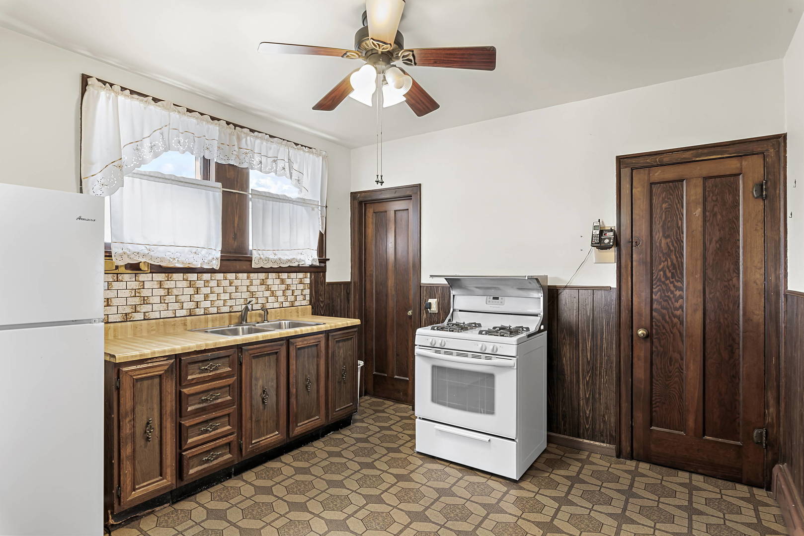 2425 North Mango Avenue Chicago, IL 60639 - Photo 8 of 17 a kitchen with a stove sink and refrigerator