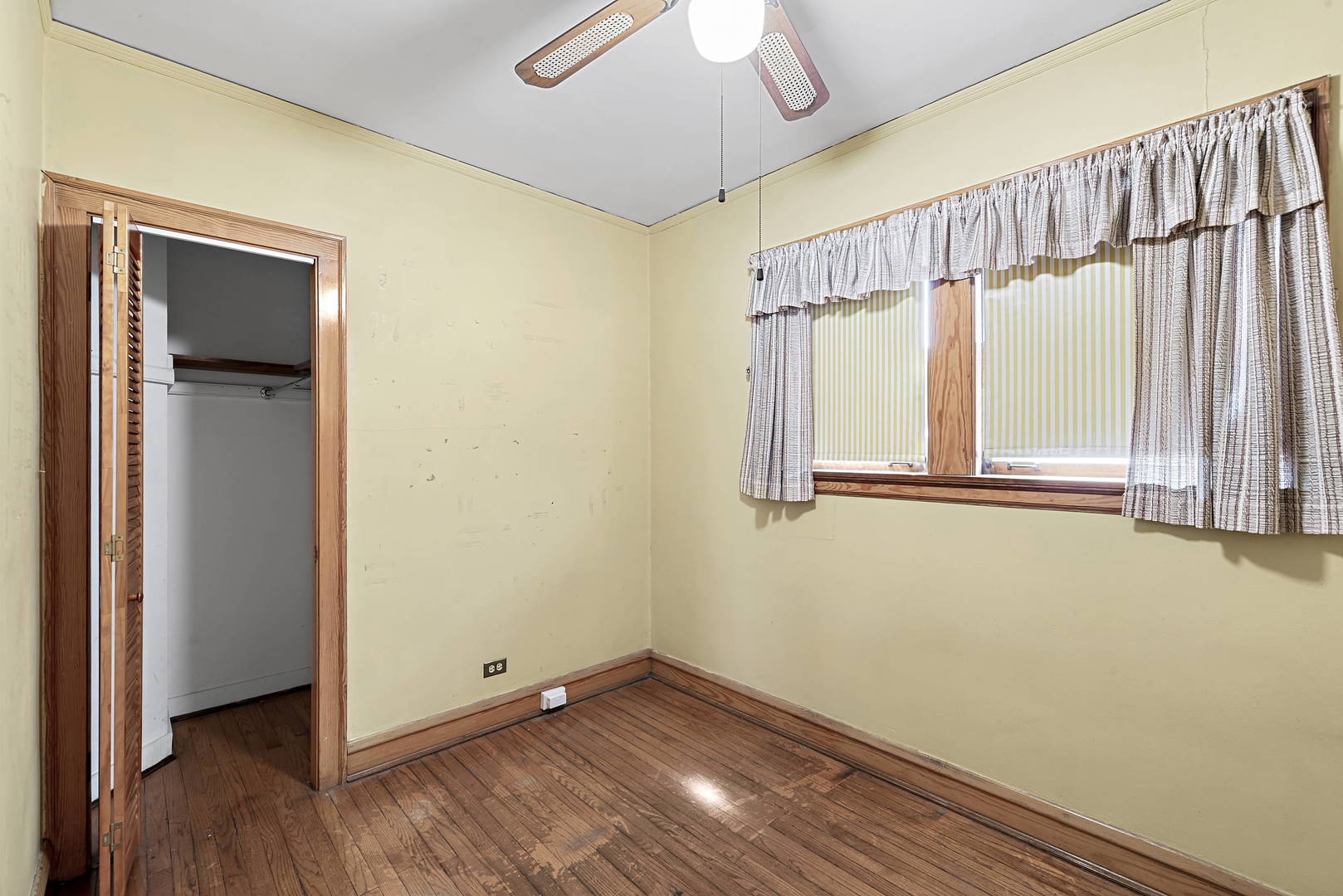 2425 North Mango Avenue Chicago, IL 60639 - Photo 10 of 17 a view of empty room with wooden floor and fan