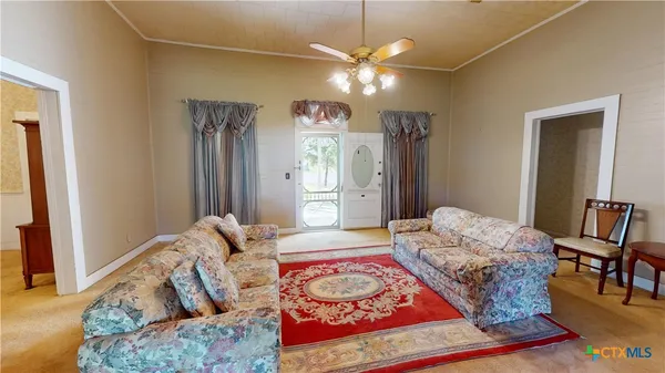 a living room with furniture and a chandelier