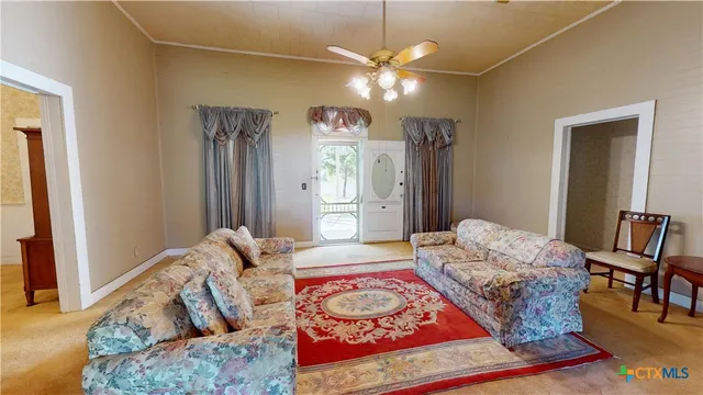 a living room with furniture and a chandelier