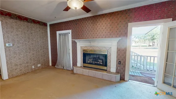 a living room with furniture and a fireplace