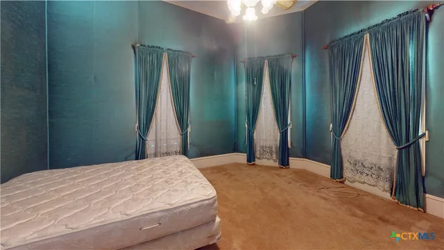 a bedroom with a bed and a mirror