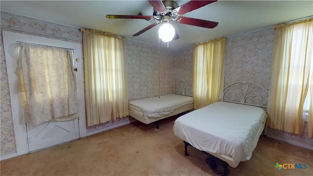 a bedroom with two beds and a chandelier