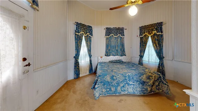 a bedroom with a bed and a chandelier