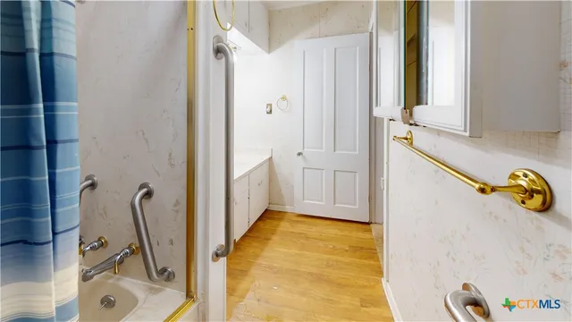 a view of a bathroom with tub and mirror