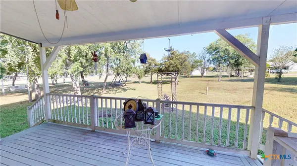 a view of a balcony with lake view and wooden floor