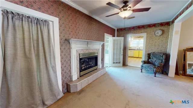 a view of a livingroom with a fireplace and a window