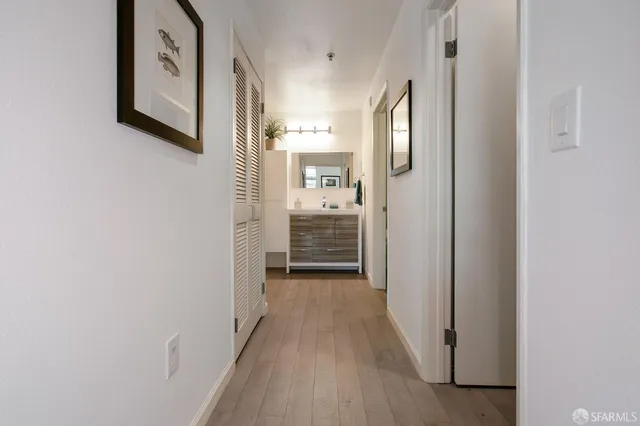 a view of a hallway view with wooden floor and staircase