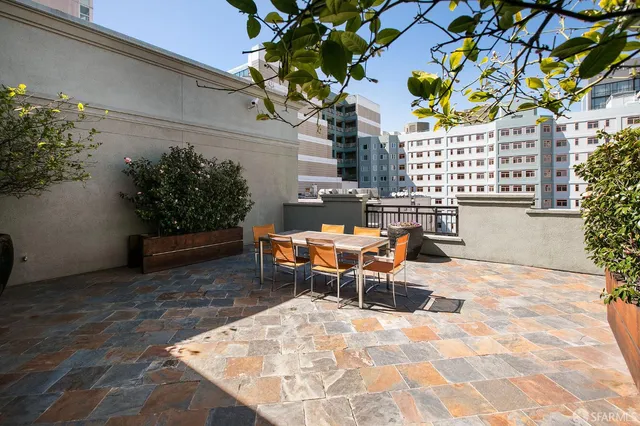 a terrace with outdoor seating and flowers