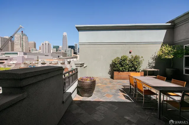 a view of a patio with table and chairs and potted plants